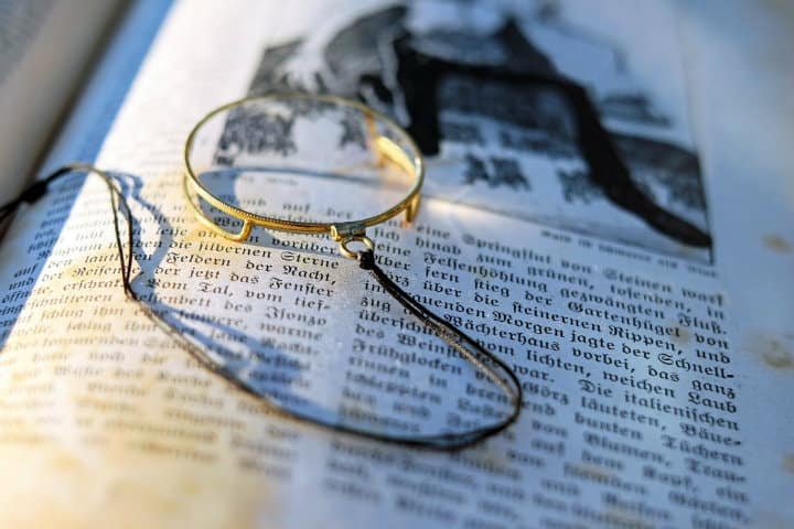 magnifying glass on an old book