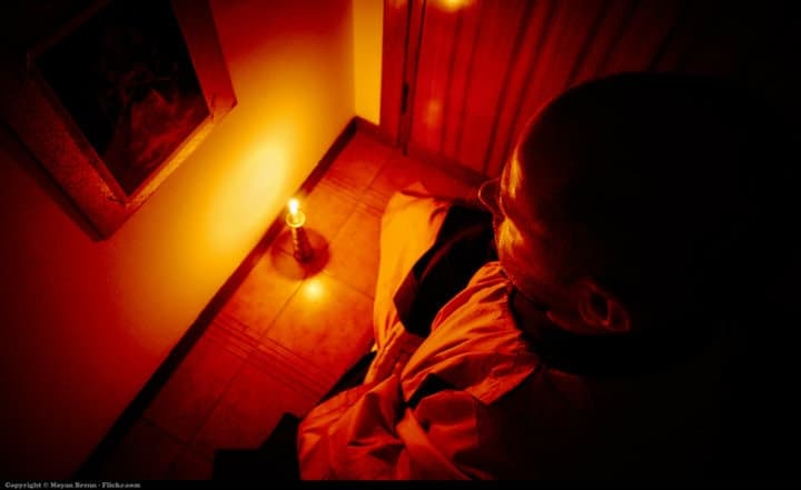monk meditating in the dark