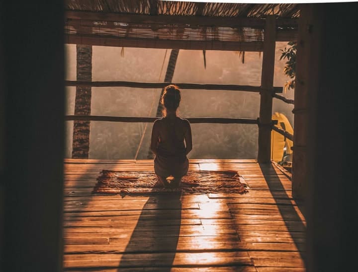 girl meditating in a tropical country on sunrise