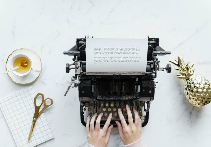 person writing on a vintage machine