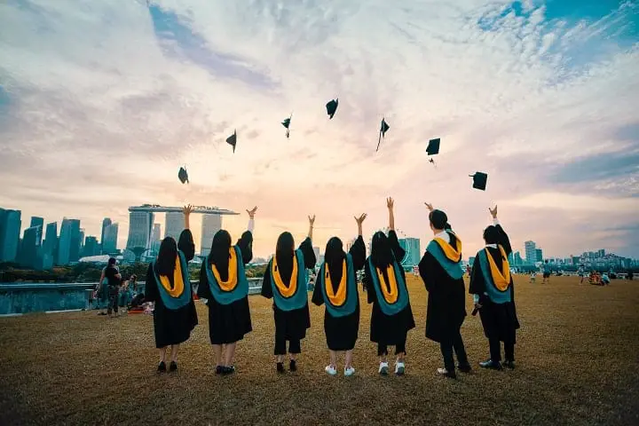 students throwing their hats in the air