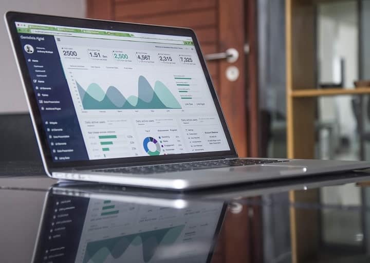 computer with analytics on a glass table