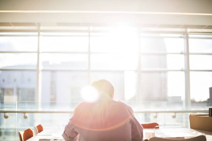 person sitting in a conference room sunny