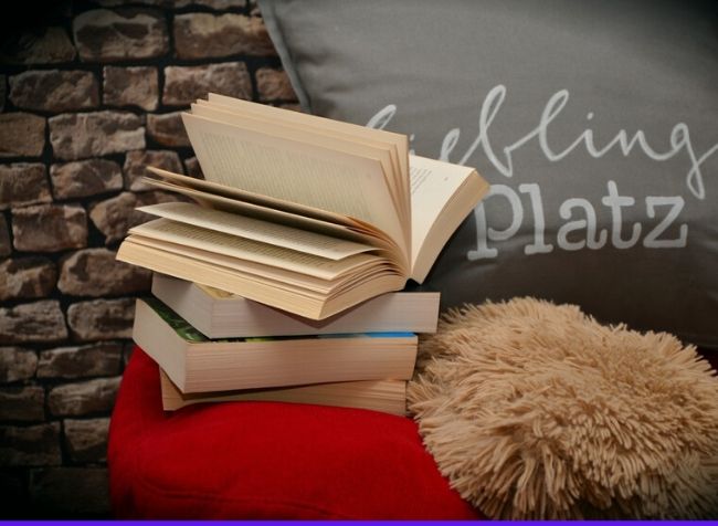 books lying on a pillow - featured image