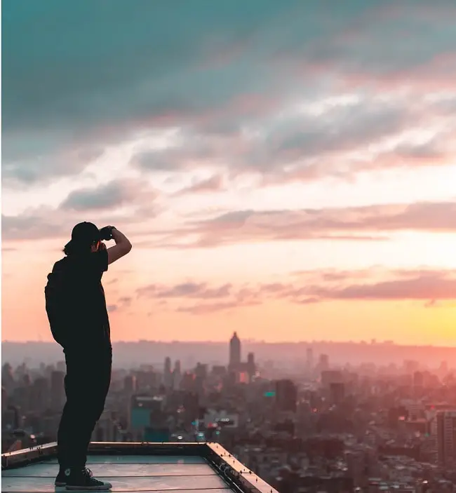 man standing on a building and taking a picture