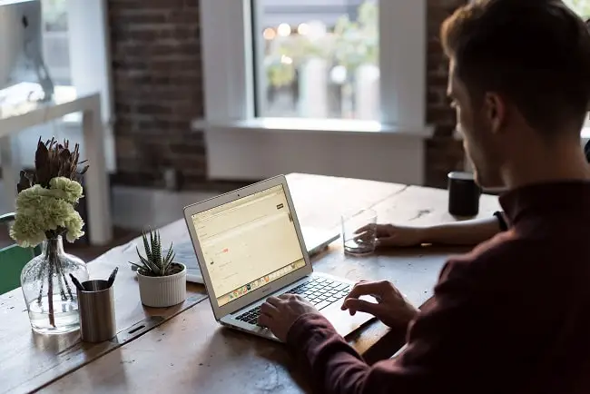 person working on a laptop at a table