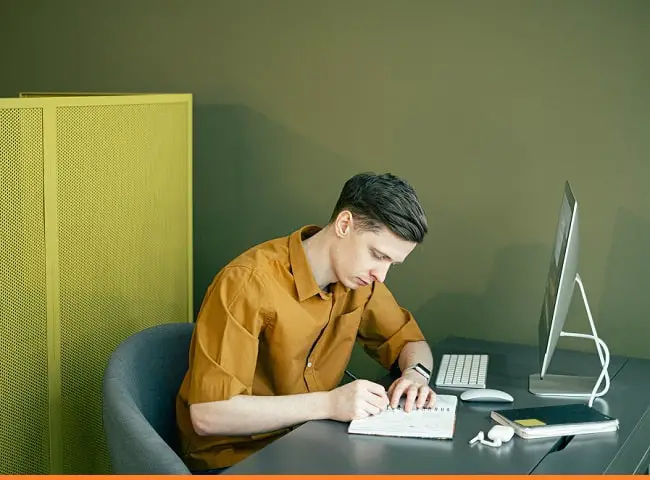 man writing outline