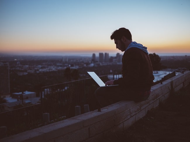 person working remotely sitting on a rooftop