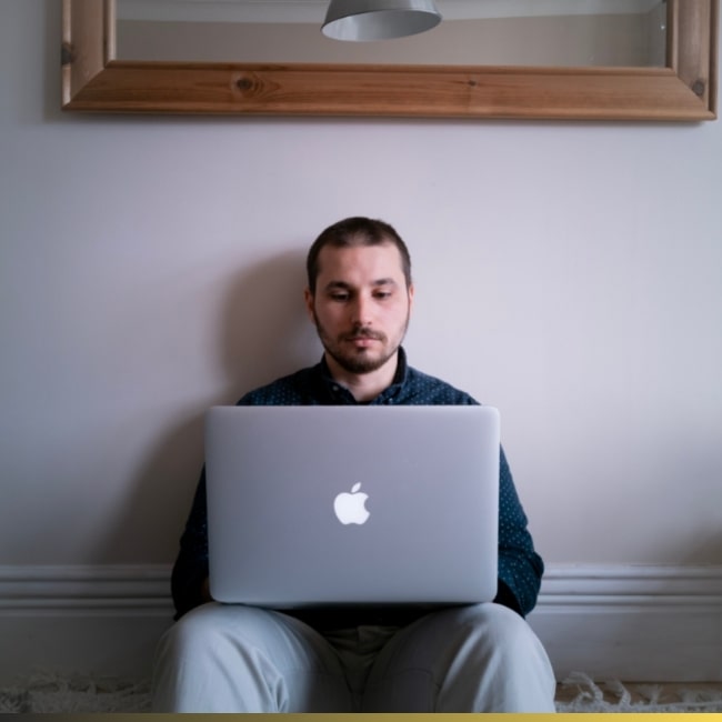 a freelancer writing on a macbook