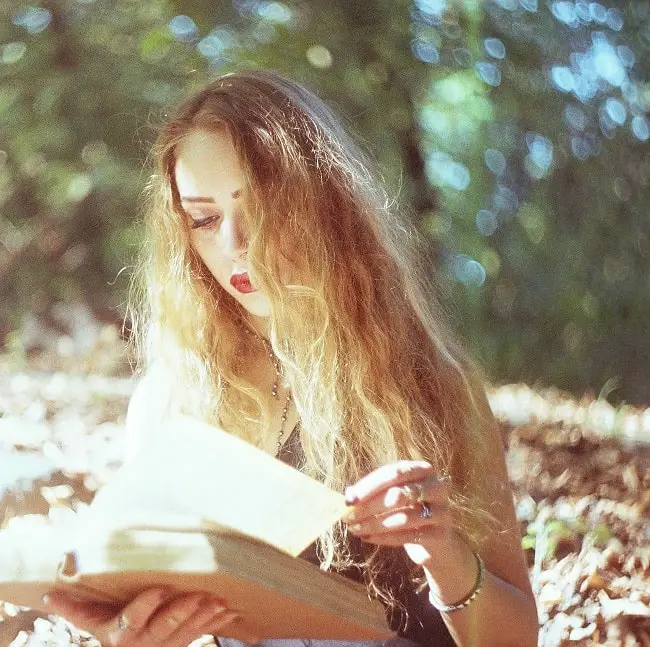 girl reading a book in sunshine