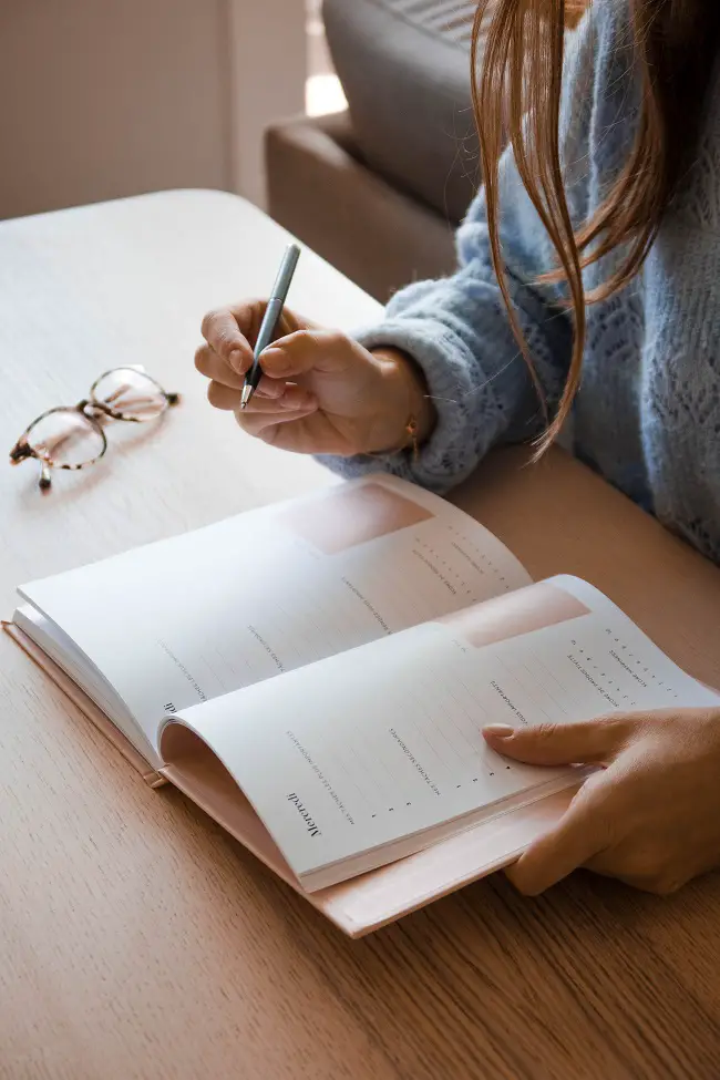 woman writing in a planner