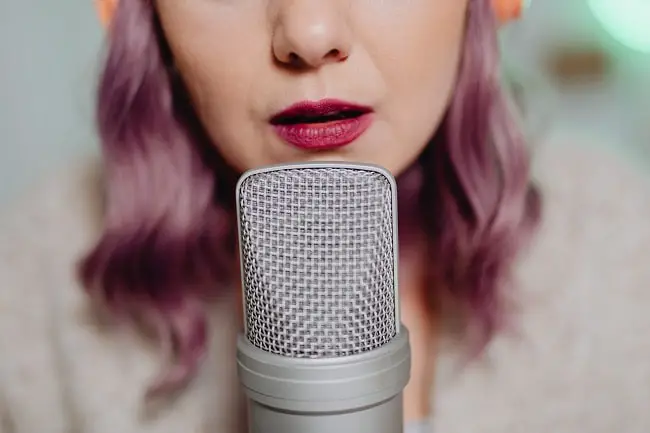 woman speaking to a microphone