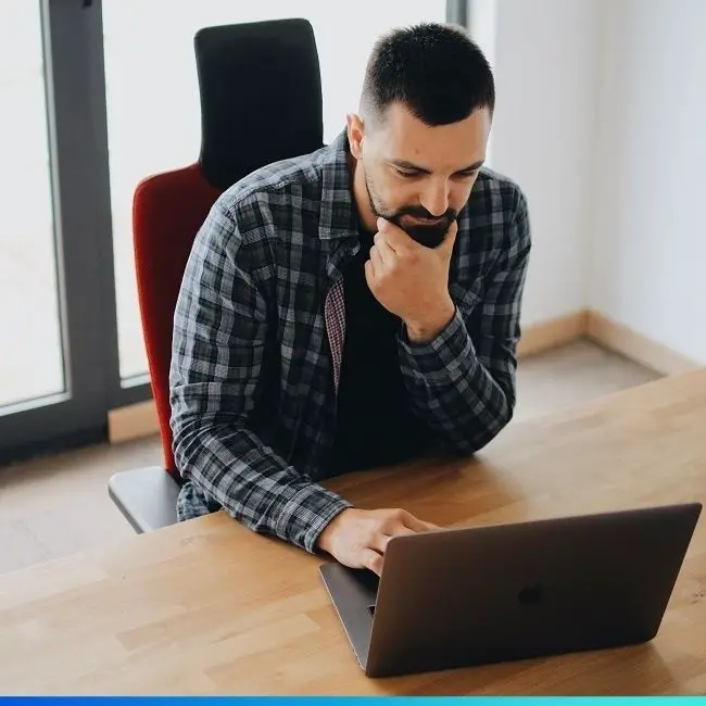 bearded man using a laptop