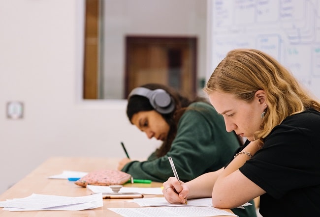 two young students writing