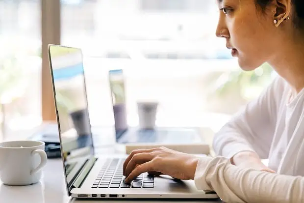 Young blogger using a laptop