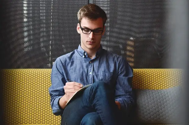 young man writing