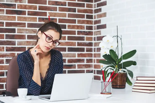 business woman sitting at a nice white desk