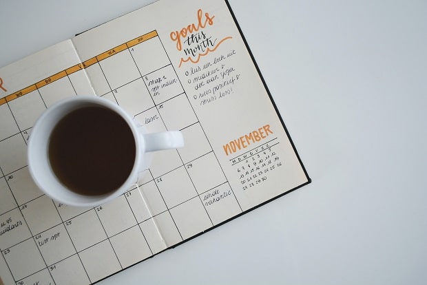 monthly planner and a coffee