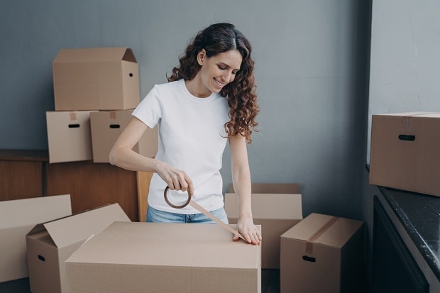 young woman packing boxes