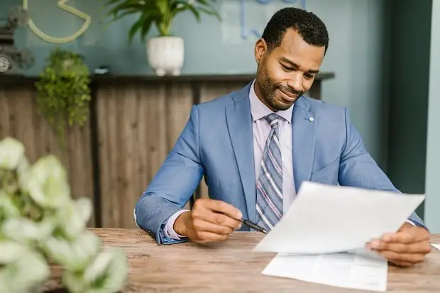 professor reading an essay of MBA applicant