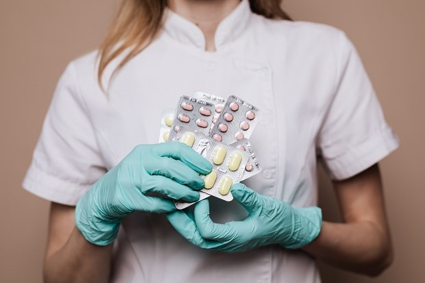 pharmacist holding medicines