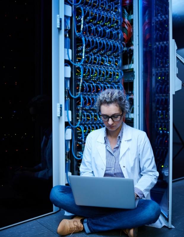 computer scientist sitting in a server room