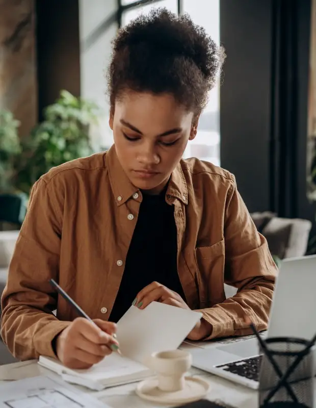 young woman writing in a notebook