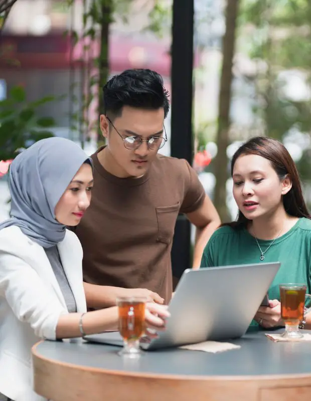 a group of asian freelancers working in open air