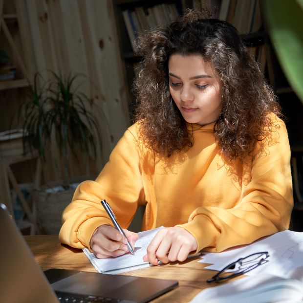 Young female student writing an essay