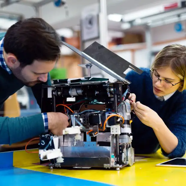 tech people working on a complicated device