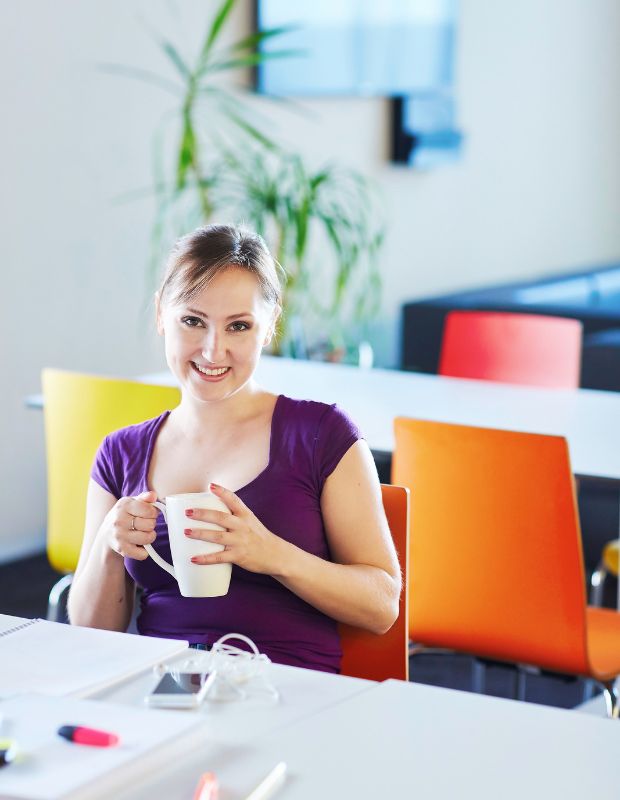 young female student drinking a cup of coffee