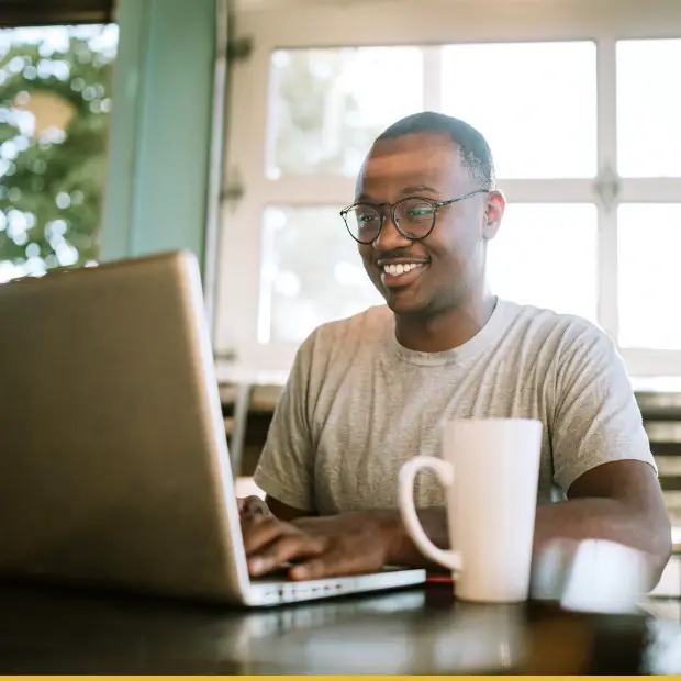 Young freelancer typing on a laptop keyboard