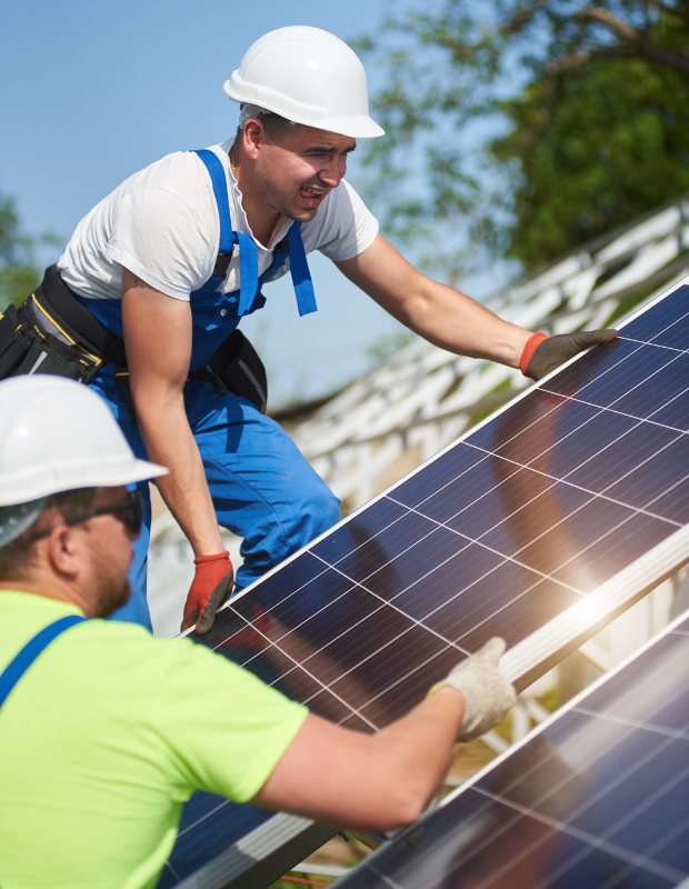 professionals installing solar panels on a roof