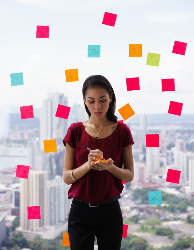 girl with sticky notes posted on a glass wall
