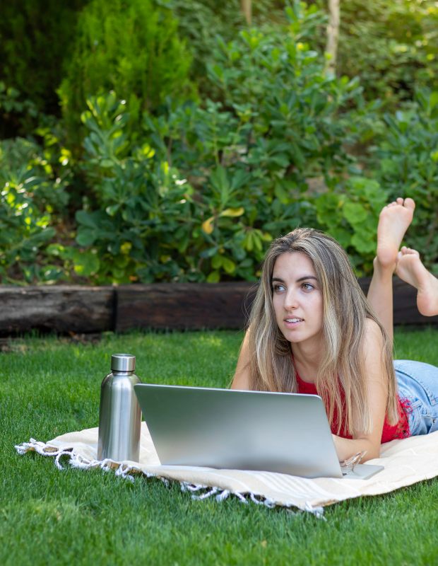 a digital nomad woman working on a lawn