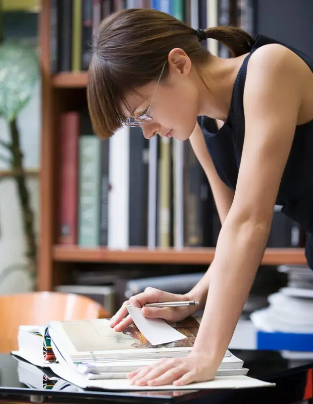 female researcher conducting research in a library