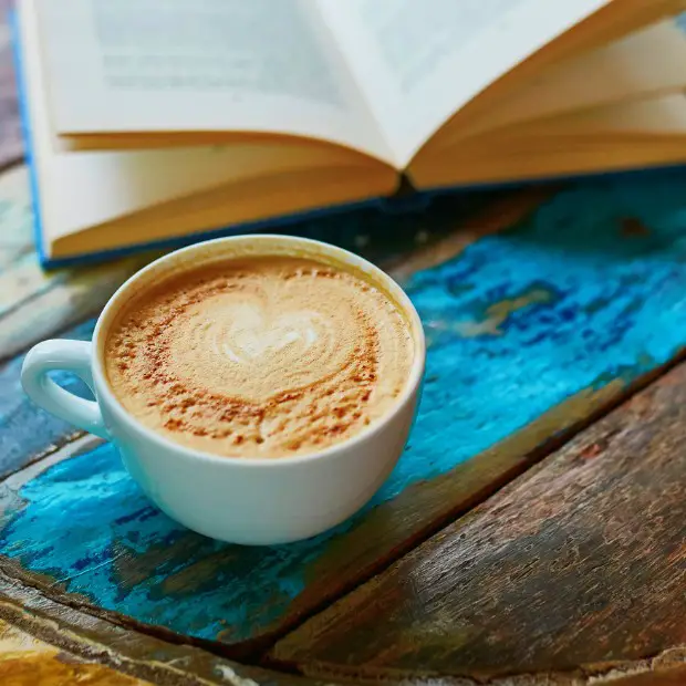 a book and coffee mug on a beautiful ethnic table