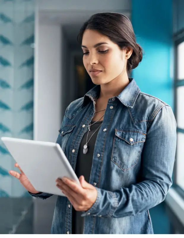 a young woman holding a tablet in a medical setting