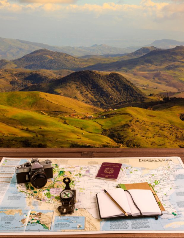 beautiful landscape and a map and compass on a table